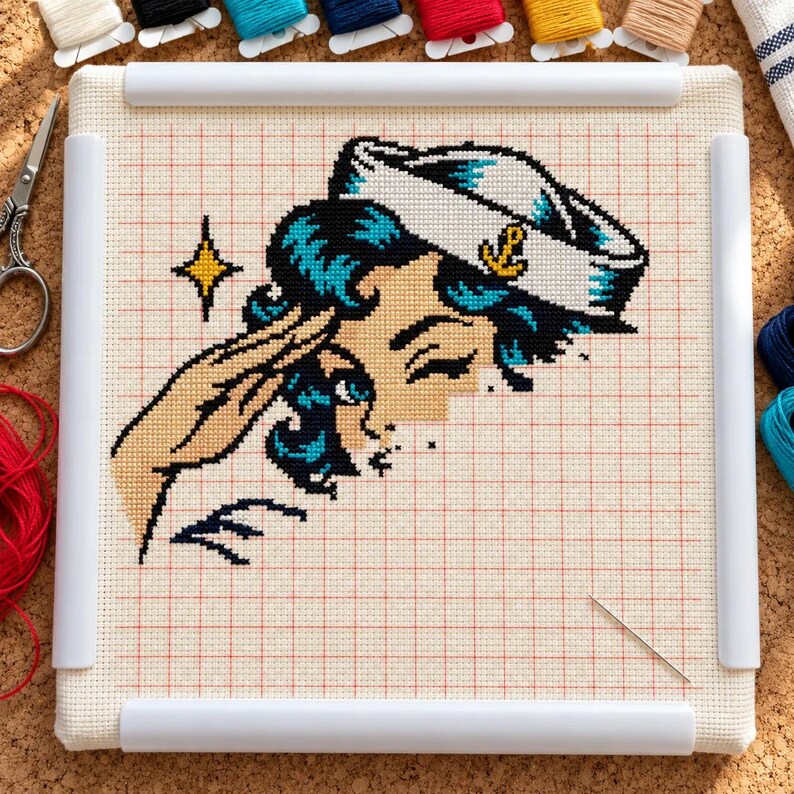 Sailor girl cross stitch in progress in a Q-snap frame