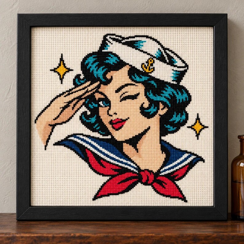 Straight-on view of the finished Sailor Girl Cross Stitch in a black frame on a wooden shelf