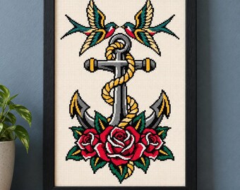 May include: A framed cross-stitch embroidery featuring a central gray anchor wrapped in a yellow rope, flanked by two swallows at the top and three red roses with green leaves at the base, all set against a cream-colored fabric background.