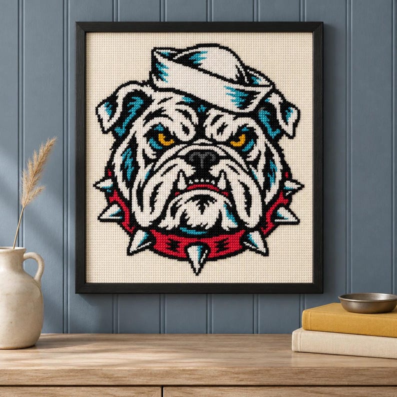 Close view of the framed sailor bulldog cross stitch hanging on a wall