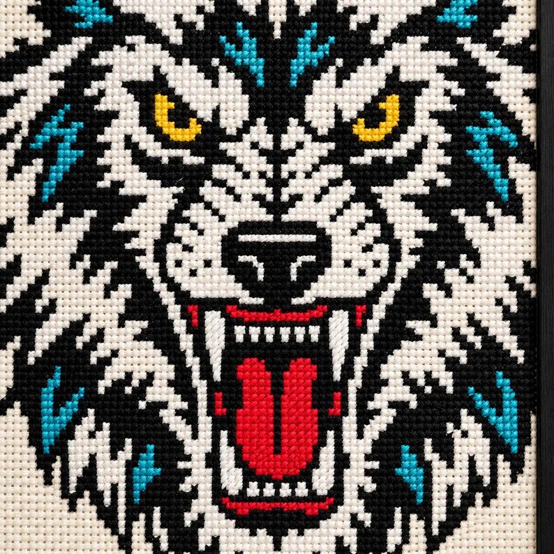 Macro of the stitched wolf muzzle showing fangs and yellow eyes