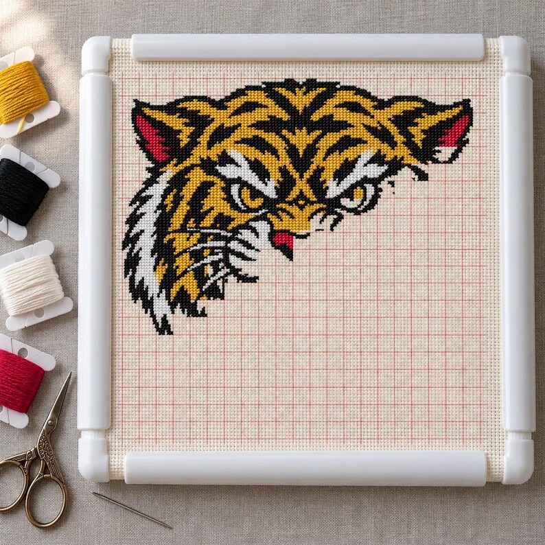 Tiger cross stitch in progress in a Q-snap frame