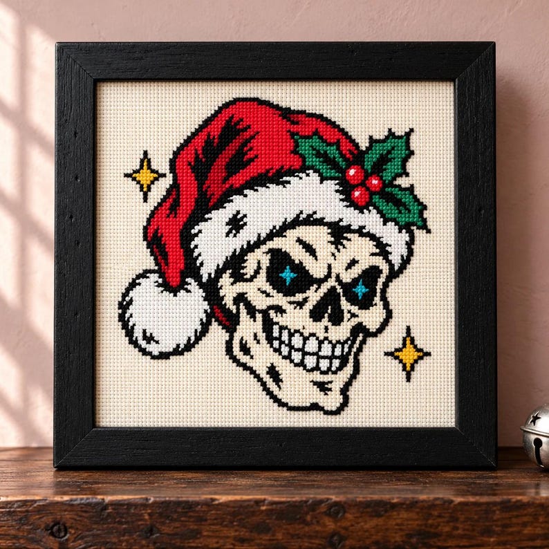 Straight-on view of the finished Skull Santa Hat Cross Stitch in a black frame on a wooden shelf