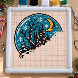 Snow globe cross stitch in progress in a Q-snap frame