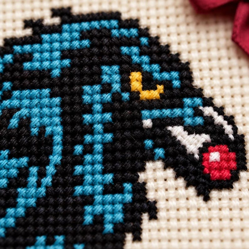 Macro of the stitched raven head and red berry