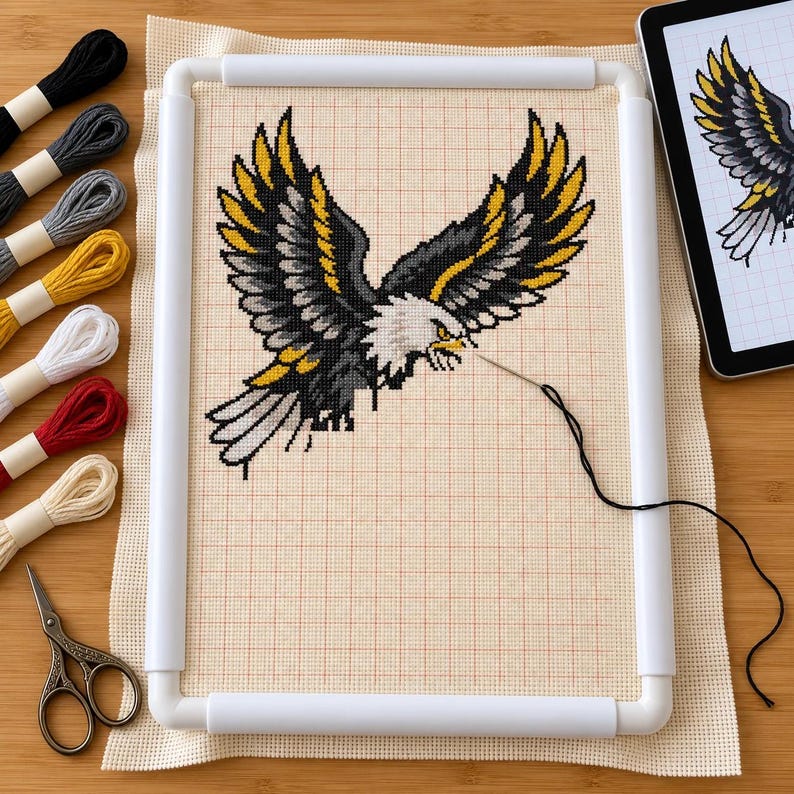 Eagle and snake cross stitch in progress in a Q-snap frame