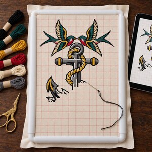 Anchor cross stitch in progress on a scroll frame with floss and scissors