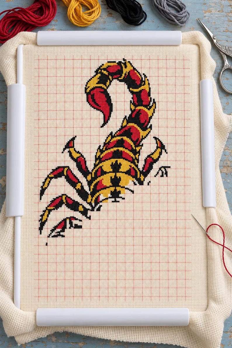 Scorpion cross stitch in progress in a Q-snap frame