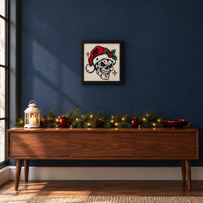 Framed skull in a Santa hat cross stitch on a wall