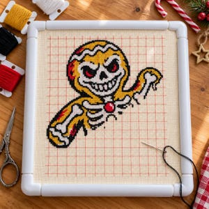 Gingerbread skeleton cross stitch in progress in a Q-snap frame