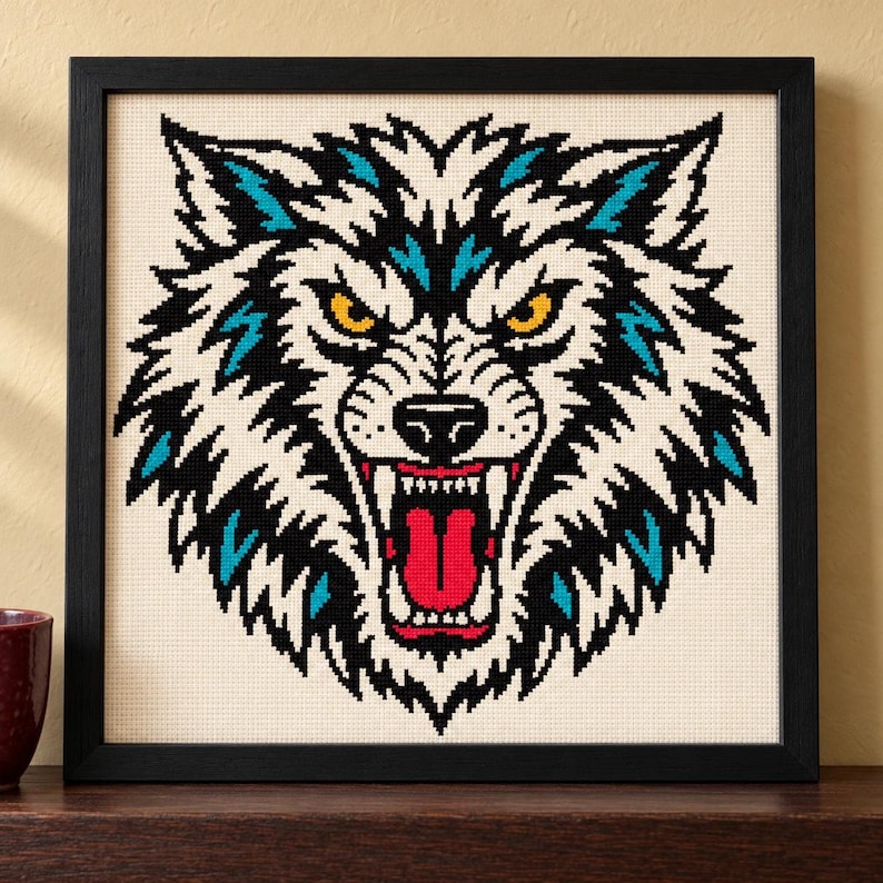 Straight-on view of the finished Wolf Cross Stitch in a black frame on a wooden shelf