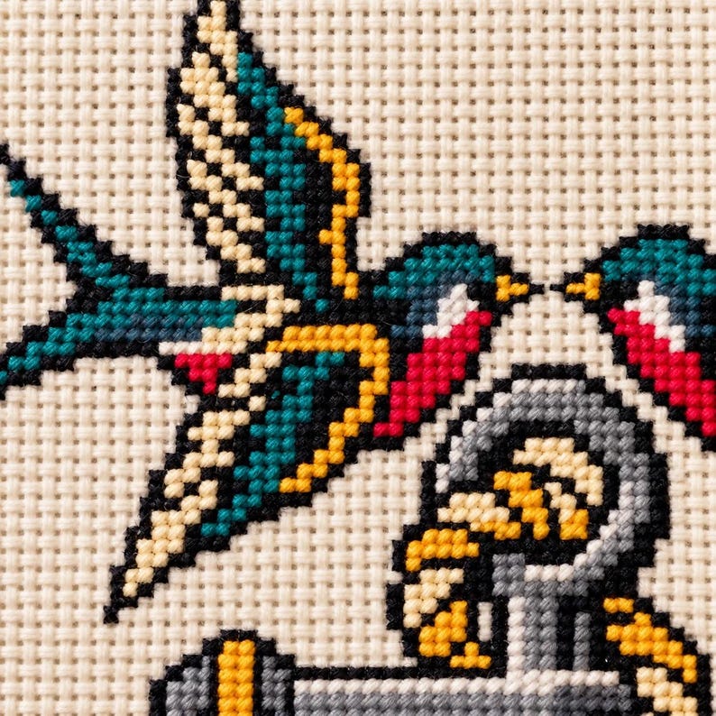 Macro of the stitched swallows above the anchor ring