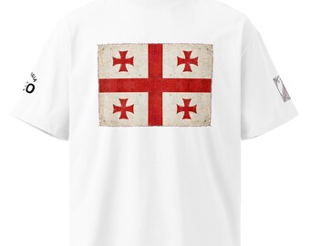 May include: A white short-sleeve t-shirt featuring a large, weathered-look rectangular graphic of the Georgia flag with a red cross and four smaller red crosses. The text "GIA" and "50" are printed on the left sleeve, with a small emblem on the right.