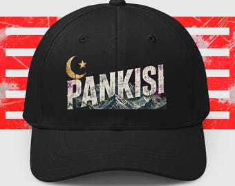 May include: A black baseball cap featuring a graphic print on the front. The design includes the text PANKISI in distressed white lettering, a gold crescent moon and star symbol, and a detailed illustration of snow-capped mountain peaks.