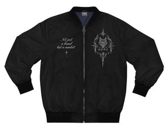 May include: A black bomber jacket with a front zipper, featuring a white graphic of a wolf head inside an ornate frame with the text BORZ, and the phrase Not just a brand but a mindset printed on the right side with a small star symbol.