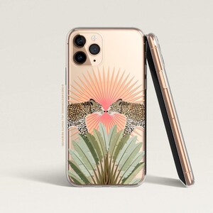 May include: A clear phone case with a gold background and a design of two leopards kissing in front of a pink and orange sunburst. The case has a black border and a clear back.