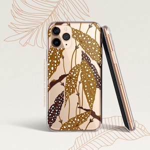 May include: A clear phone case featuring a brown and white leaf design. The case is compatible with an iPhone and has a camera bump cutout.