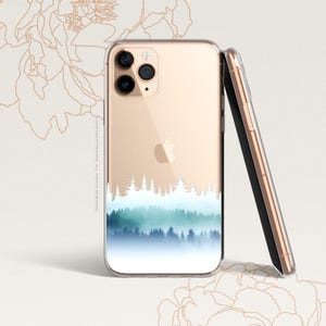 May include: A clear phone case with a gold border and a watercolour design of a forest with blue and green trees. The case is designed for an iPhone with a camera bump.