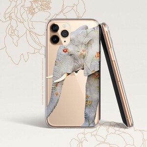 May include: A clear phone case with a gold trim and a floral design featuring an elephant. The elephant is grey with pink flowers and green leaves.