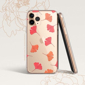 May include: A clear phone case with a gold background and a pattern of red and orange ginkgo leaves. The case is designed for an iPhone.