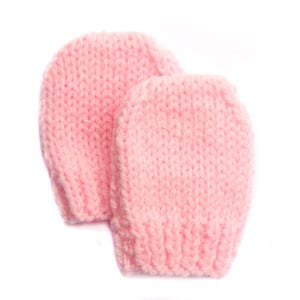 May include: A pair of pink knitted baby mittens. The mittens are soft and warm, perfect for keeping little hands cozy.