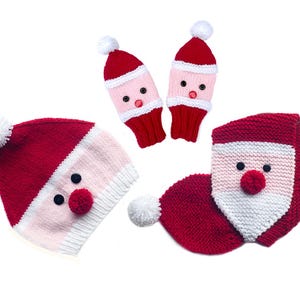 May include: A festive collection of knitted Christmas accessories, featuring a Santa Claus design. The set includes a red and white hat with a pom-pom, a matching scarf, and two pairs of mittens. Each item has a Santa face with button eyes and a red pom-pom nose.