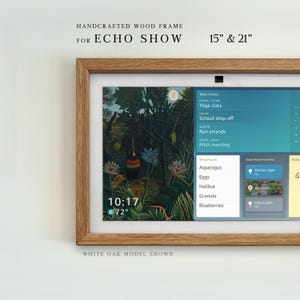 May include: A light brown wood frame designed for an Echo Show, featuring a rectangular shape with a natural grain finish. The frame surrounds a digital display showing a jungle-themed background, a clock, weather, and a smart home dashboard.
