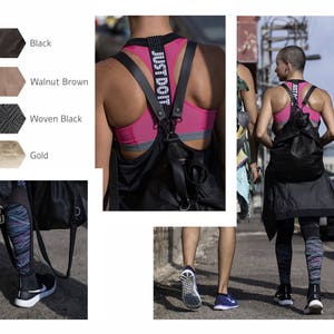 May include: Two women wearing black athletic wear and carrying black bags. One woman is wearing a pink sports bra with a black strap that says "Just Do It". The other woman is wearing a black tank top with a black bag. Both women are wearing black leggings.