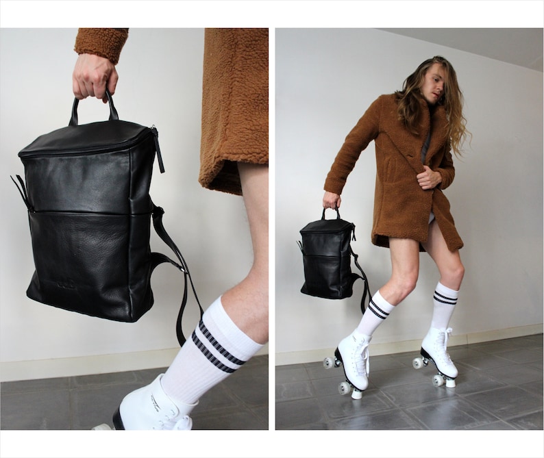 May include: A black leather backpack with a single strap and a white and black striped sock on a person's leg.