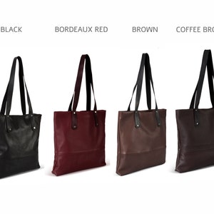 May include: Four leather tote bags in different colors: black, burgundy, brown, and dark brown. Each bag has a black handle and a zipper closure.