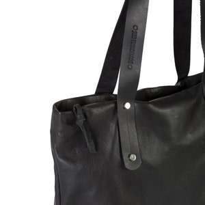 May include: Black leather tote bag with two long straps. The straps have the text "OLD MADE" embossed on them.