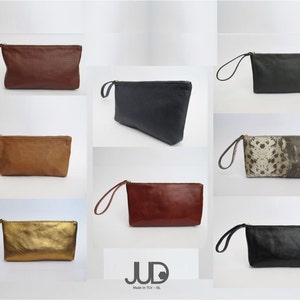 May include: A set of ten leather clutches in various colors and patterns, including brown, tan, black, gold, and a snakeskin print. The clutches have a zipper closure and a small handle.