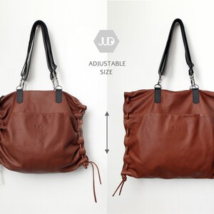 May include: A brown leather tote bag with adjustable straps and a drawstring closure. The bag has a logo on the front that says "JD". The text "Adjustable Size" is printed on a white background.