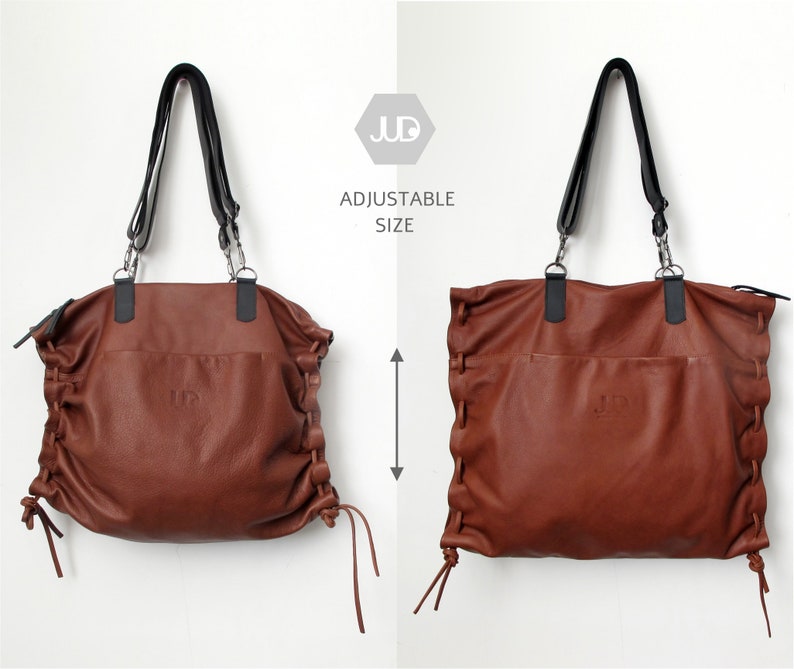 May include: A brown leather tote bag with adjustable straps and a drawstring closure. The bag has a logo on the front that says "JD". The text "Adjustable Size" is printed on a white background.