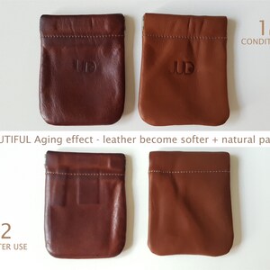 May include: Two brown leather pouches with the word "JUD" embossed on them. The pouch on the left is new and the pouch on the right has been used and shows signs of aging. The text "1 NEW CONDITION" is above the pouches on the left and the text "2 AFTER USE" is below the pouches on the right.