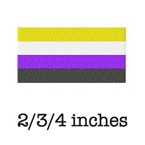 May include: A non-binary pride flag with yellow, white, purple, and black horizontal stripes. The flag is 2/3/4 inches.