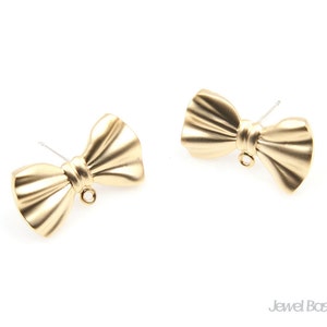 May include: A pair of gold-tone bow-shaped earring charms with a loop at the top for attaching to jewelry.