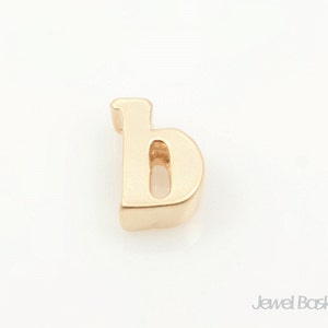 May include: Gold lowercase letter 'b' charm. The letter is solid and has a slightly rounded font.