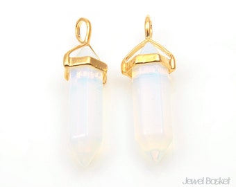 May include: Two gold-toned pendant charms featuring clear, iridescent crystal points with a hexagonal base.