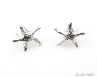 May include: A pair of silver starfish stud earrings. The starfish are textured and have a slightly raised design.