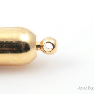 May include: Gold-toned metal end cap with a round loop for attaching a necklace or bracelet. The end cap has a smooth, polished finish.