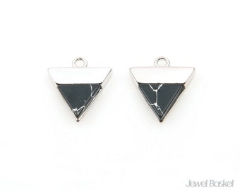 May include: Two silver triangle pendant charms with black and white marbled stone inserts. The charms have a loop at the top for attaching to a necklace or bracelet.