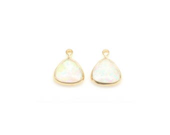 May include: Two gold-toned triangle-shaped pendants with iridescent white opal-like stones.