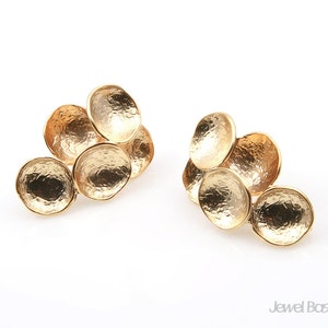 May include: A pair of gold-toned earrings with a cluster of five round, textured discs. Each earring features a cluster of five discs in a cascading design.
