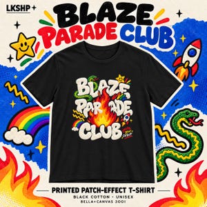 以下が含まれることがあります： 中央に白い文字で「BLAZE PARADE CLUB」と炎のイラストが描かれた黒いTシャツ。デザインには緑色のヘビ、小さな虹、ロケット、そして赤と白で「ignite your orbit」というテキストが含まれています。