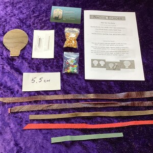 May include: A craft kit with components for making a Native Echoes item. Includes leather strips, beads, a paper template, and a card. The paper reads "Native Echoes". A label reads "5.5 cm".
