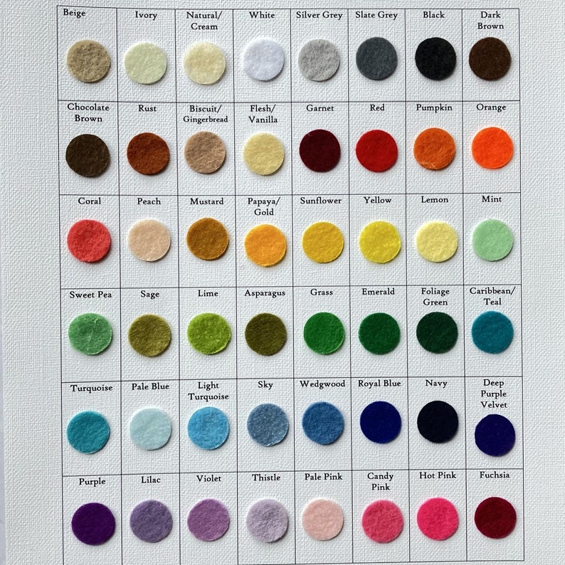 May include: A color chart with 6 rows and 10 columns of felt circles. Each circle is labeled with a color name, such as Beige, Ivory, Natural/Cream, White, Silver Grey, Slate Grey, Black, Dark Brown, Chocolate Brown, Rust, Biscuit/Gingerbread, Flesh/Vanilla, Garnet, Red, Pumpkin, Orange, Coral, Peach, Mustard, Papaya/Gold, Sunflower, Yellow, Lemon, Mint, Sweet Pea, Sage, Lime, Asparagus, Grass, Emerald, Foliage Green, Caribbean/Teal, Turquoise, Pale Blue, Light Turquoise, Sky, Wedgwood, Royal Blue, Navy, Deep Purple Velvet, Purple, Lilac, Violet, Thistle, Pale Pink, Candy Pink, Hot Pink, and Fuchsia.