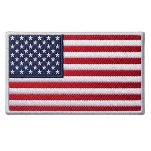 May include: A rectangular embroidered patch featuring the flag of the United States of America. The design includes a dark blue canton with white stars and alternating horizontal red and white stripes, all bordered by a white stitched edge.