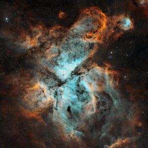 May include: A vibrant nebula featuring swirling clouds of bright cyan and deep orange gas set against a dark, star-filled space background. The gaseous structures form intricate, flowing patterns with dense, dark patches.