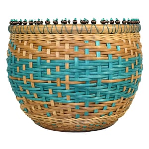 May include: A woven basket with a teal and brown pattern. The basket has a beaded rim.